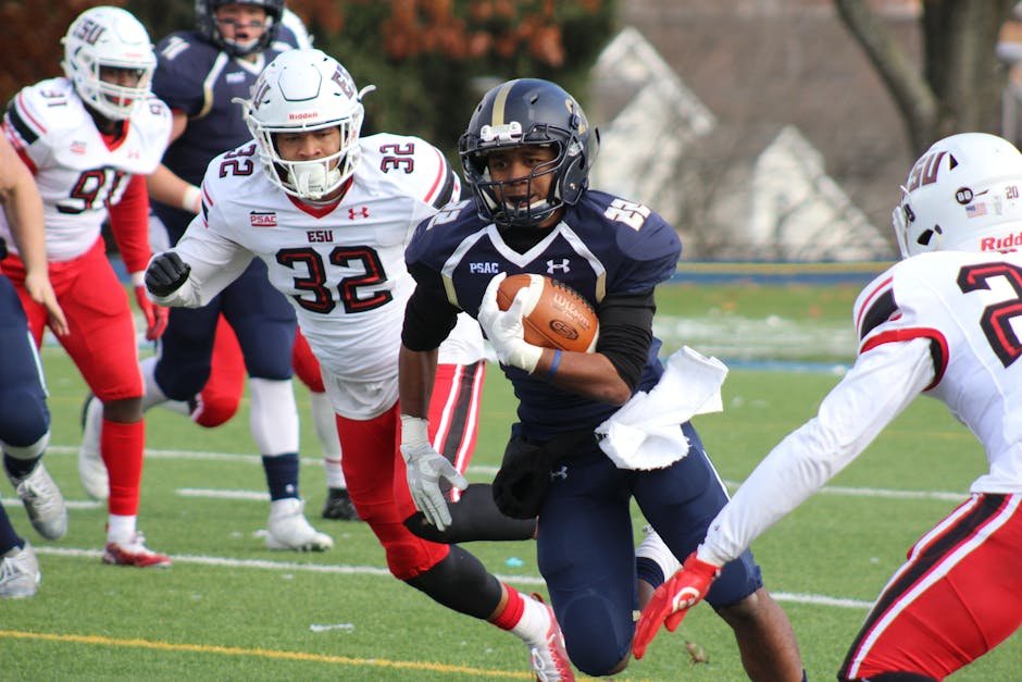Dynamic college football match with players in action, showcasing athleticism and teamwork on the field.