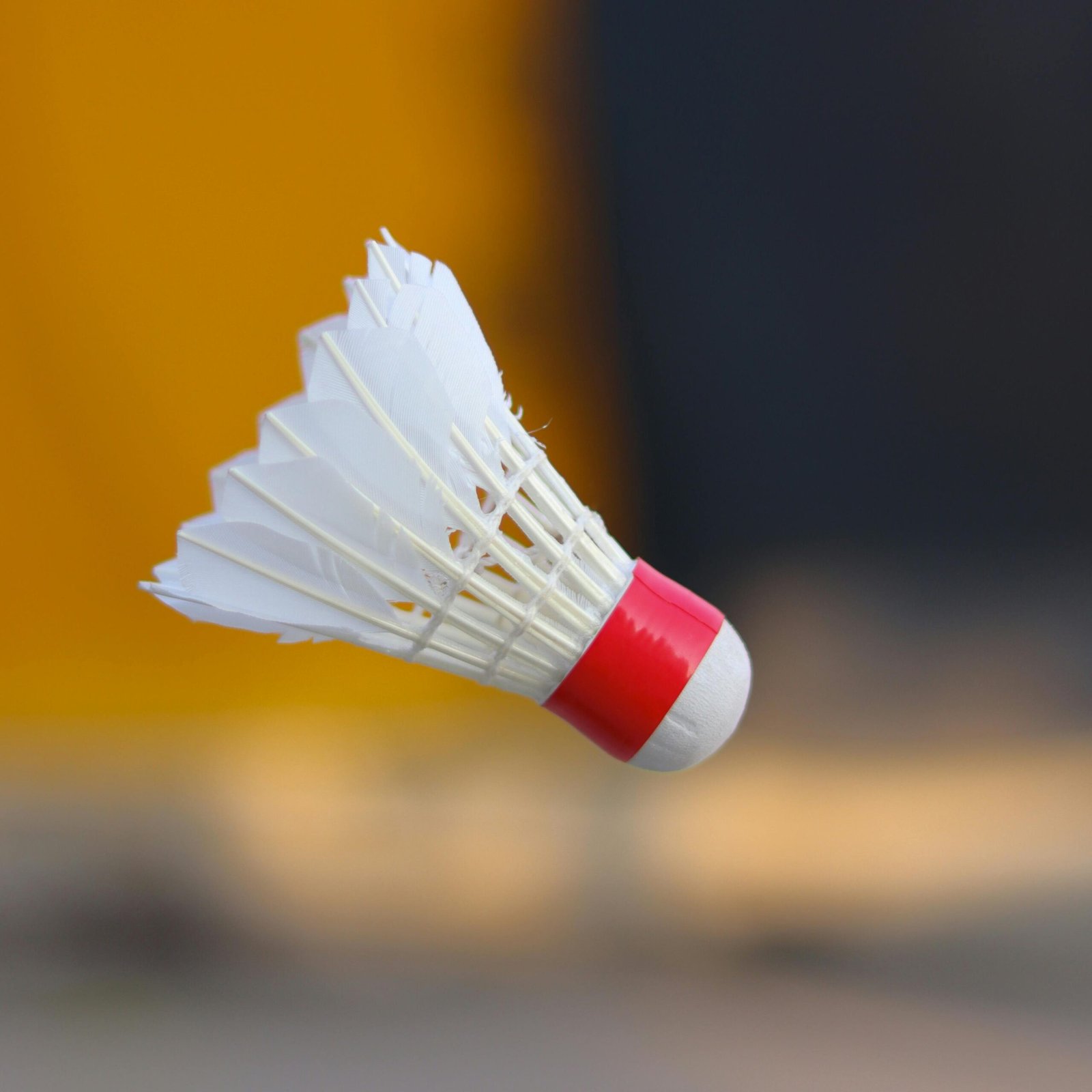 Close-up of a shuttlecock soaring through the air, emphasizing motion and sportsmanship.
